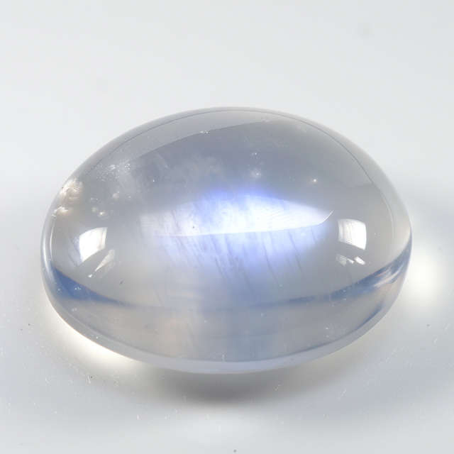 A polished white moonstone cabochon.